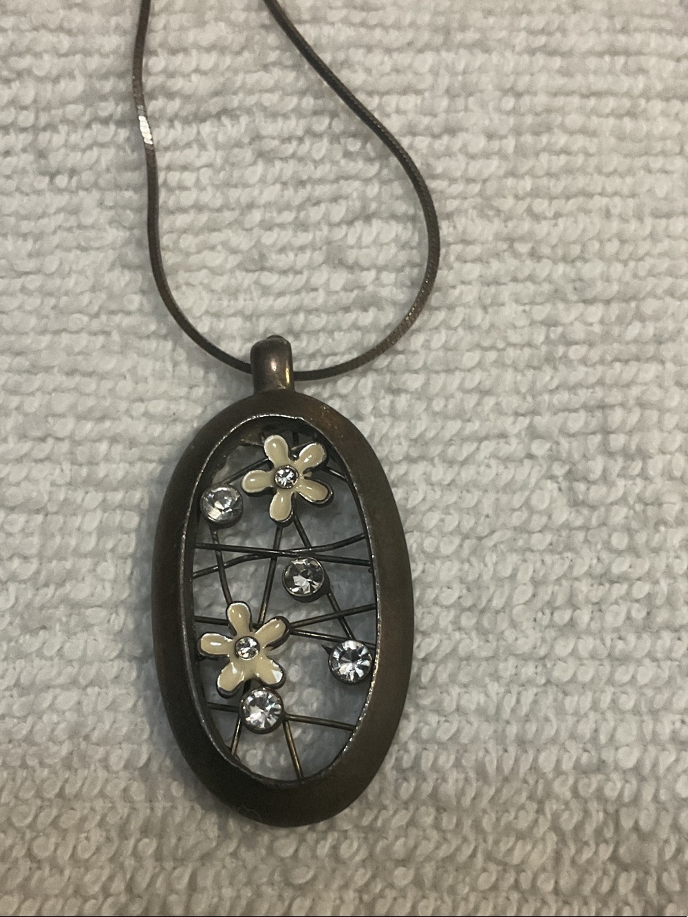Bronze Oval Pendant Necklace with Cream Flower Accents